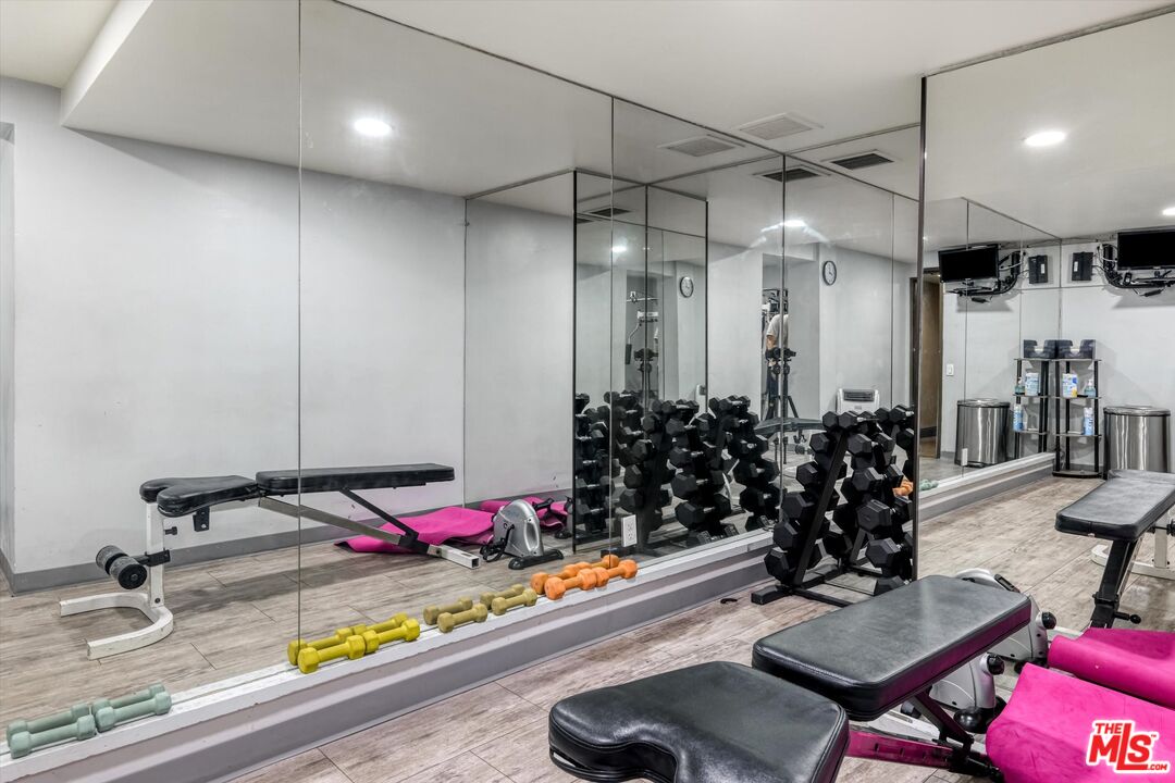 10590 Wilshire Boulevard, Unit 504 Los Angeles, CA 90024 - Photo 44 of 53 a room with gym equipment and a table