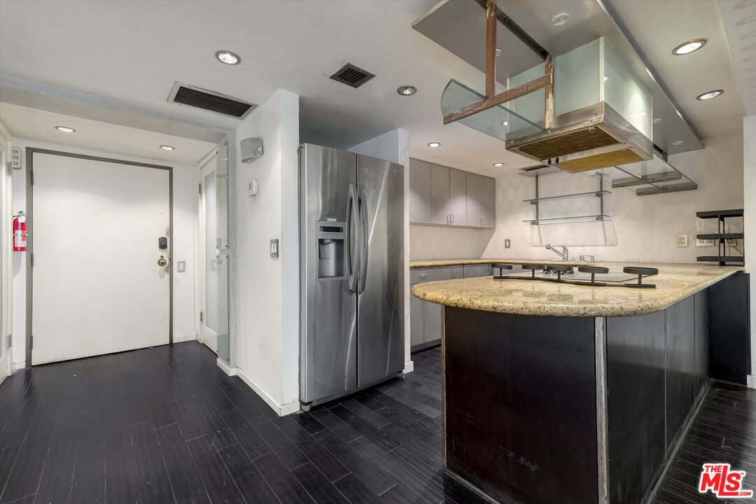 10590 Wilshire Boulevard, Unit 504 Los Angeles, CA 90024 - Photo 6 of 53 a bathroom with a sink a mirror and a shower