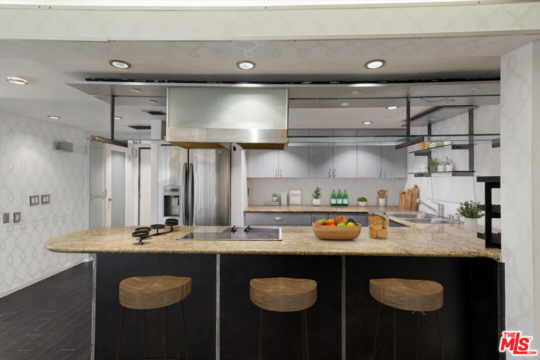 10590 Wilshire Boulevard, Unit 504 Los Angeles, CA 90024 - Photo 7 of 53 a kitchen with stainless steel appliances granite countertop a sink stove and cabinets