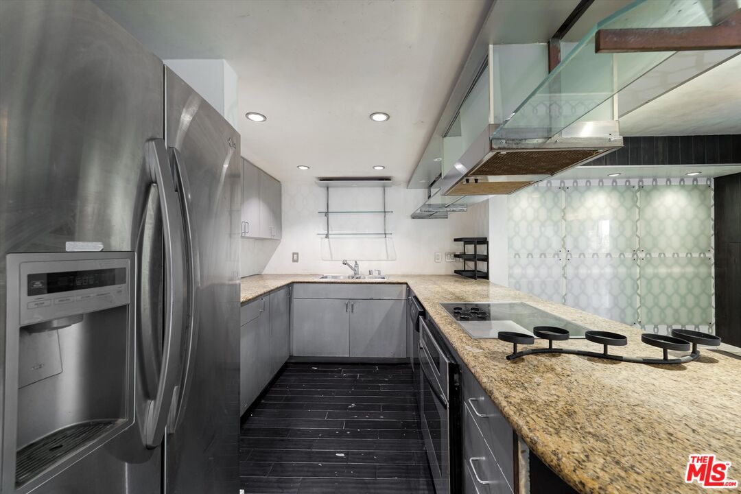 10590 Wilshire Boulevard, Unit 504 Los Angeles, CA 90024 - Photo 9 of 53 a kitchen with a sink stove and refrigerator