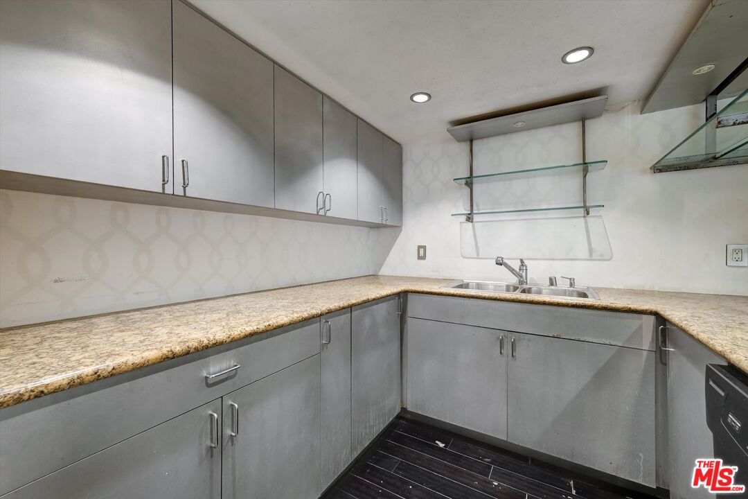 10590 Wilshire Boulevard, Unit 504 Los Angeles, CA 90024 - Photo 10 of 53 a kitchen with sink cabinets and stove
