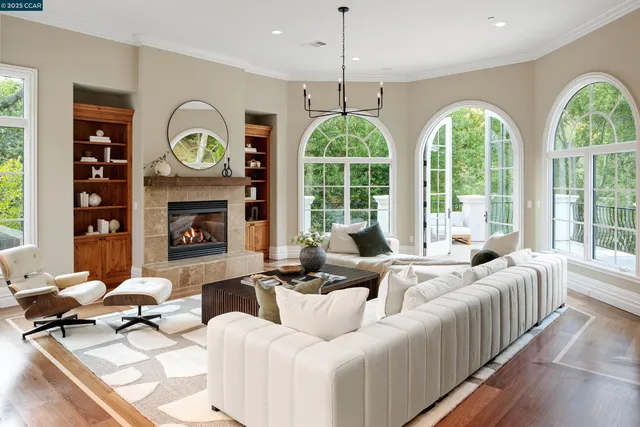 a living room with furniture fireplace and window
