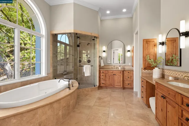 a large bathroom with a large tub sink shower and mirror