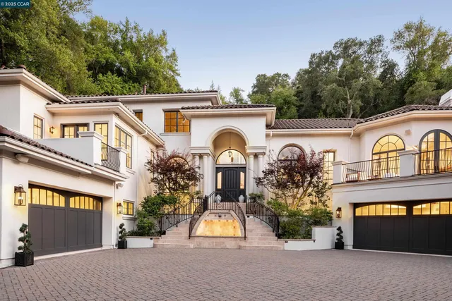 a view of a house with large windows and a clock on the wall