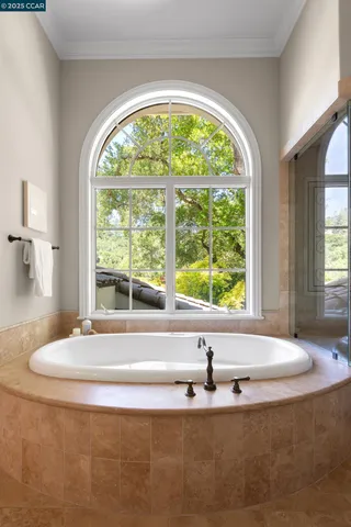 a bath tub sitting in a bathroom next to a window