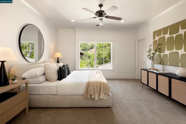 a bedroom with a bed a mirror and a large window