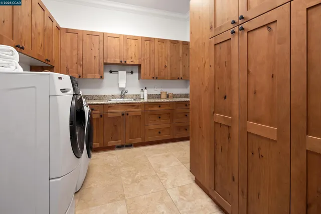 a kitchen with kitchen island a sink stainless steel appliances and cabinets
