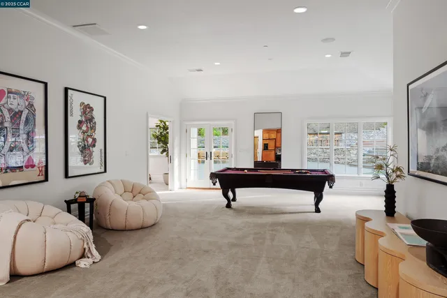 a bedroom with furniture and a large window