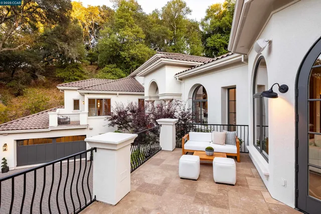 a view of a patio with couches table and chairs and potted plants
