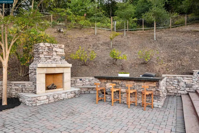 a view of a chairs and fire pit in the patio