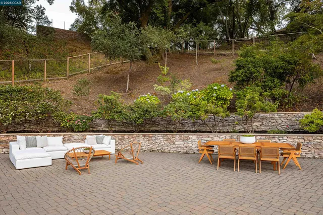 a garden with sitting area and lake view