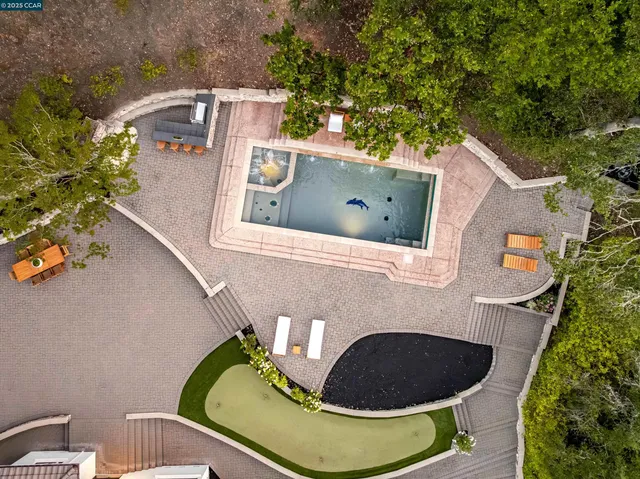 an aerial view of a house with a garden and trees