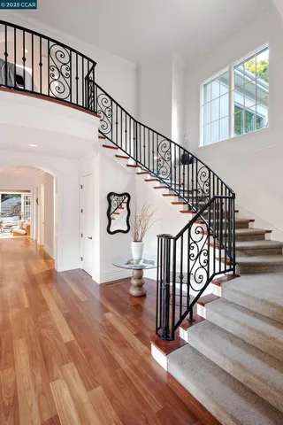 a view of entryway with wooden floor and a front door