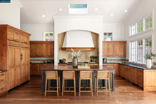 a large kitchen with lots of counter space and chairs