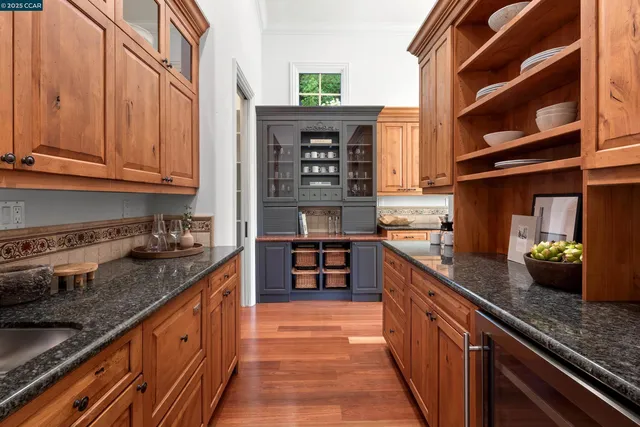 a kitchen with stainless steel appliances granite countertop a stove and cabinets