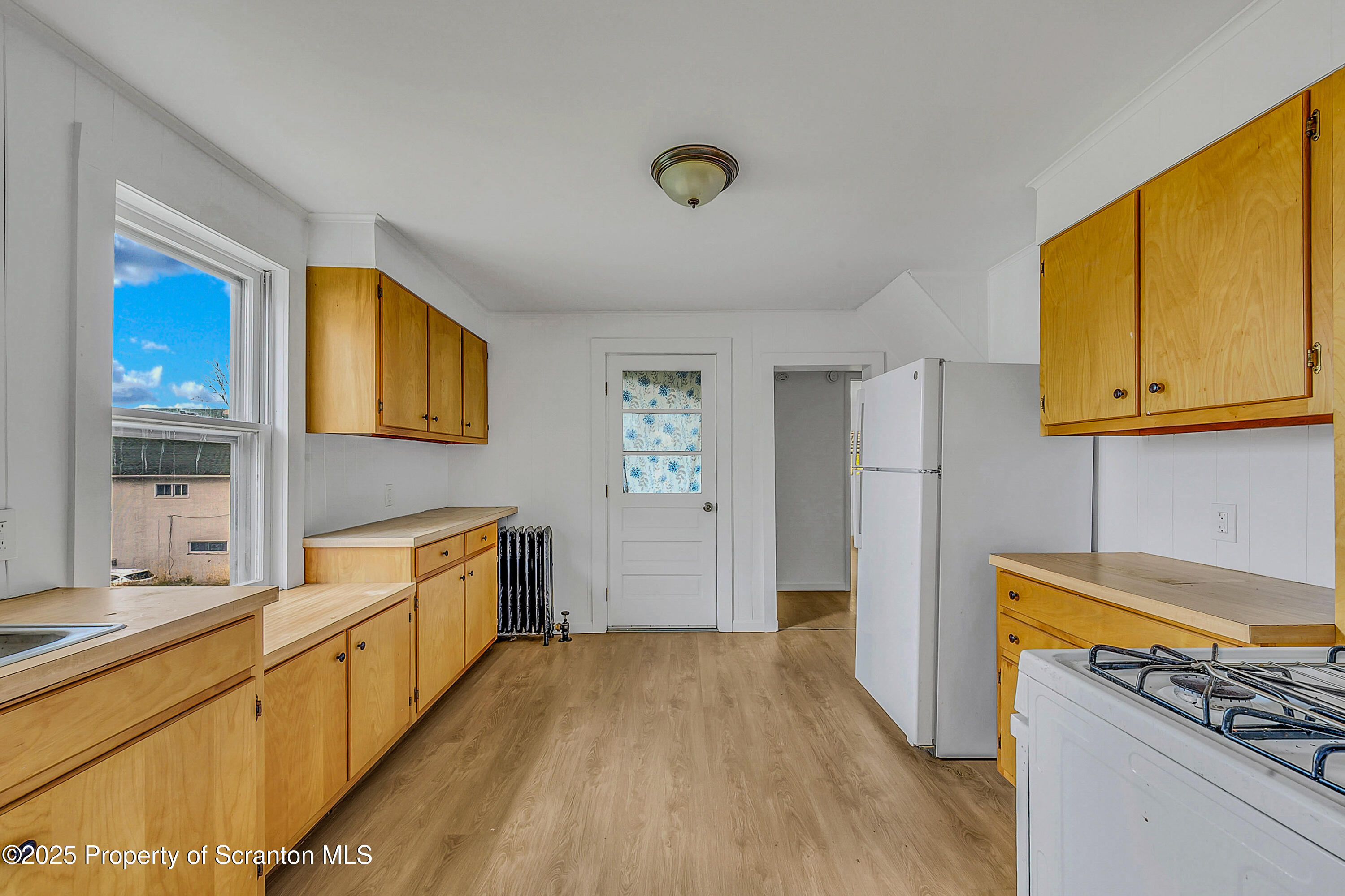1005 Luke Avenue Scranton, PA 18510 - Photo 6 of 15 a kitchen with stainless steel appliances granite countertop a sink stove and refrigerator