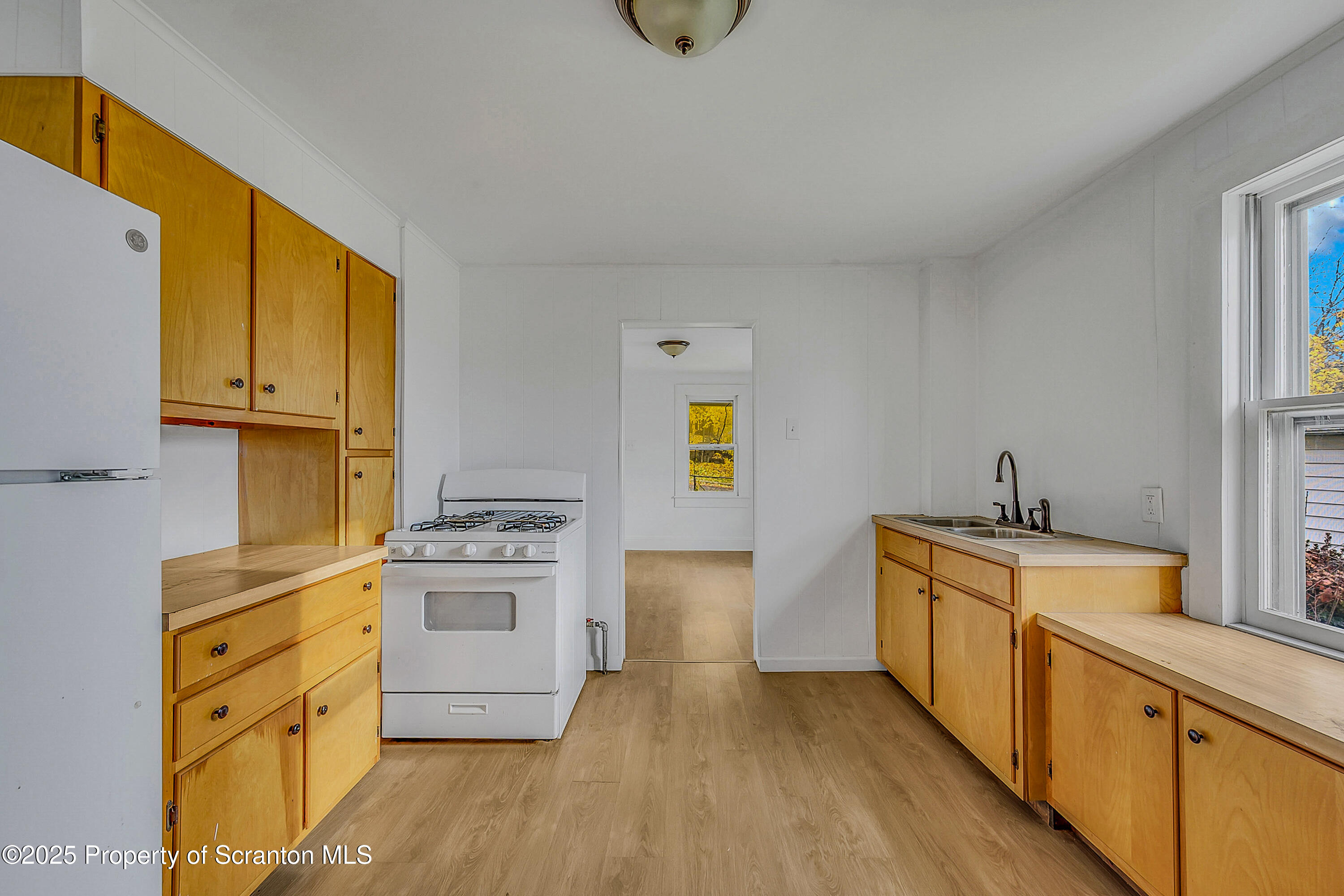 1005 Luke Avenue Scranton, PA 18510 - Photo 7 of 15 a kitchen with stainless steel appliances granite countertop a stove a sink and a refrigerator
