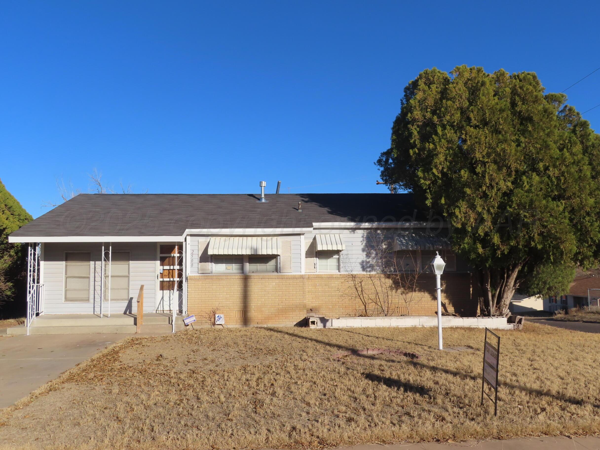 2500 Chestnut Street Amarillo, TX 79107 - Photo 1 of 8 a front view of a house with a yard