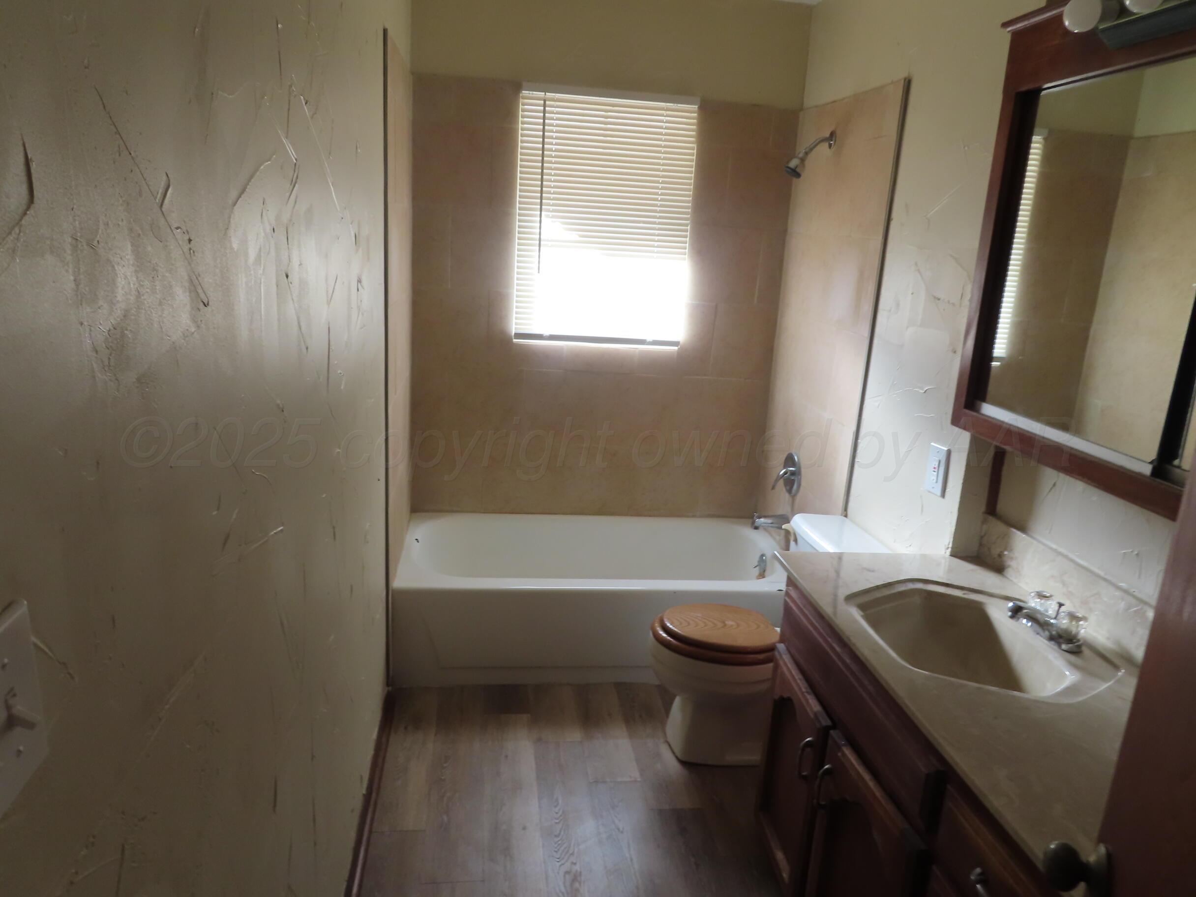 2500 Chestnut Street Amarillo, TX 79107 - Photo 5 of 8 a bathroom with a sink a toilet and tub
