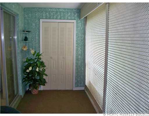 1937 Southwest Palm City Road, Unit 19C Stuart, FL 34994 - Photo 11 of 22 Other. Screened porch with 2 storage closets with view of the golf course