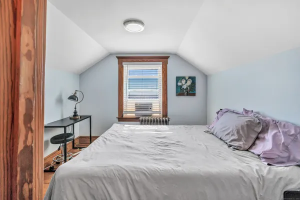 a bedroom with a bed and a window