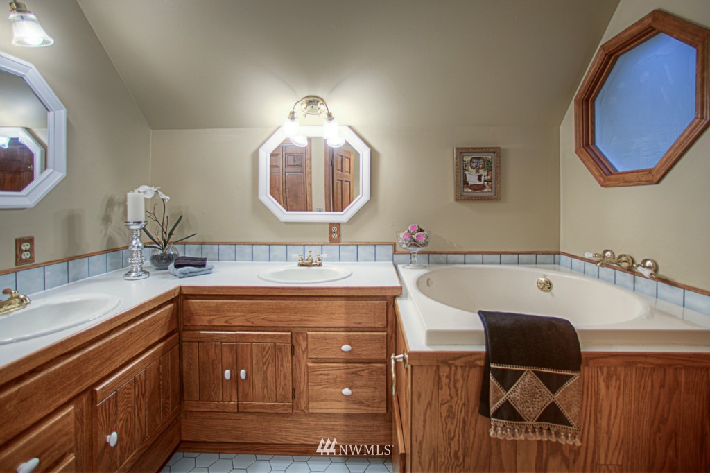 310 208th Street Southeast Bothell, WA 98012 - Photo 11 of 25 a bathroom with a double vanity sink and a mirror