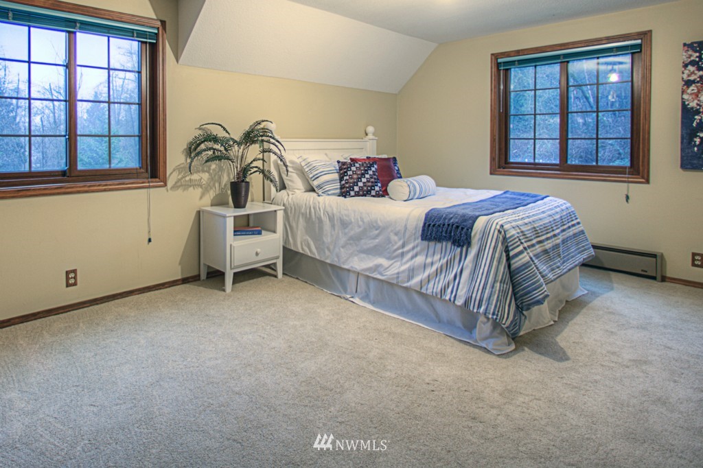 310 208th Street Southeast Bothell, WA 98012 - Photo 15 of 25 a spacious bedroom with a bed and a window