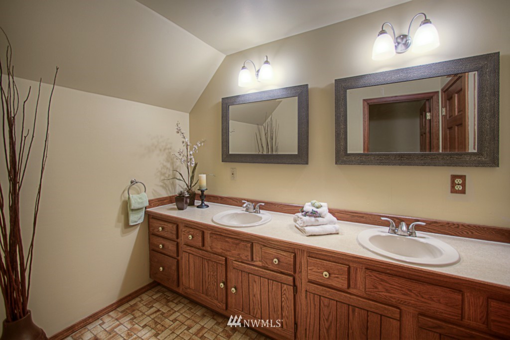 310 208th Street Southeast Bothell, WA 98012 - Photo 16 of 25 a bathroom with double sink and a mirror