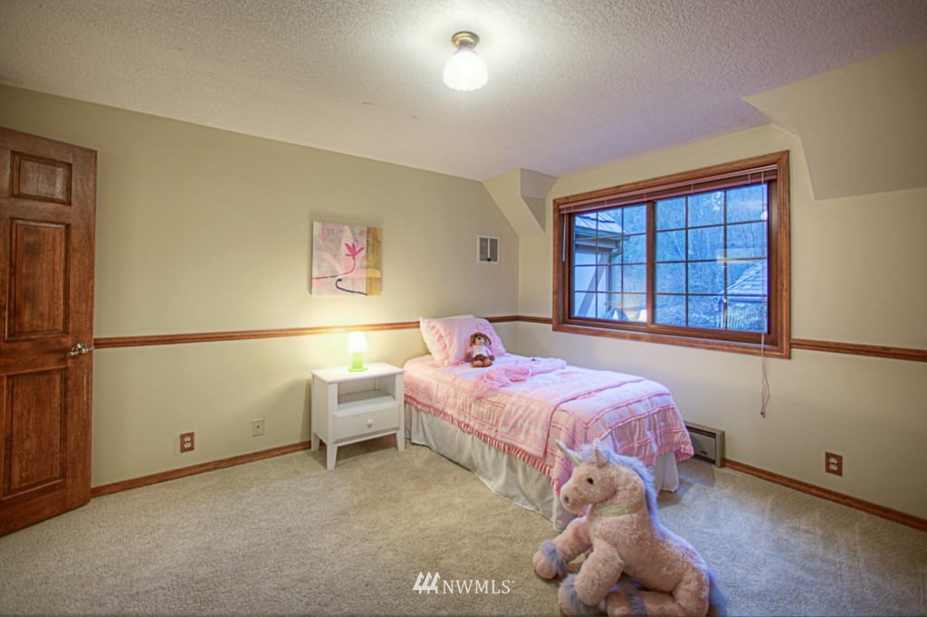 310 208th Street Southeast Bothell, WA 98012 - Photo 17 of 25 a bedroom with a bed and a window