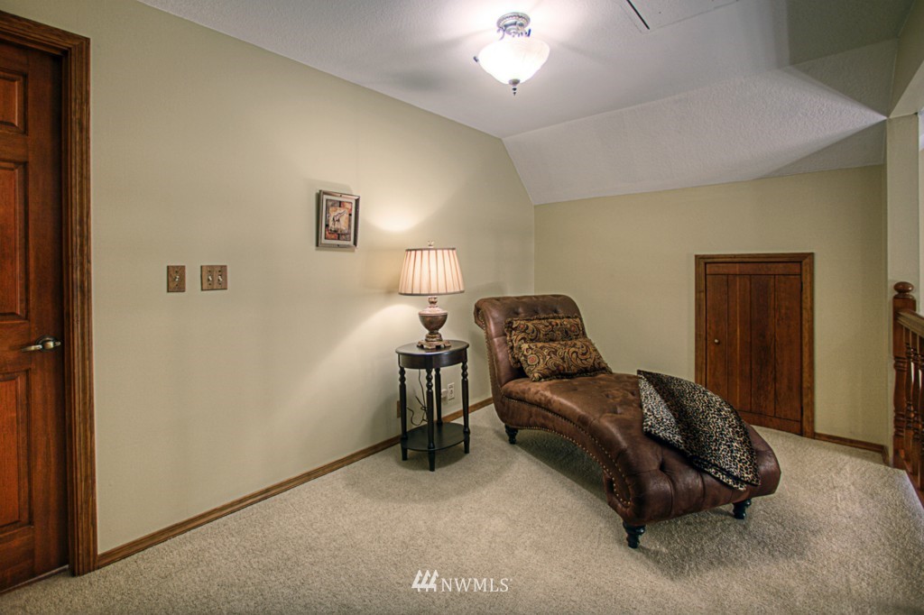 310 208th Street Southeast Bothell, WA 98012 - Photo 18 of 25 a bedroom with a bed and a lamp on the dresser