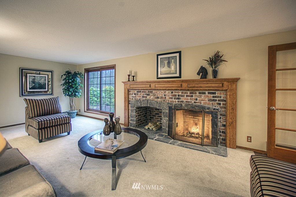 310 208th Street Southeast Bothell, WA 98012 - Photo 3 of 25 a living room with furniture and a fireplace