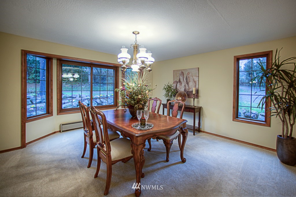 310 208th Street Southeast Bothell, WA 98012 - Photo 4 of 25 a view of a dining room with furniture and chandelier