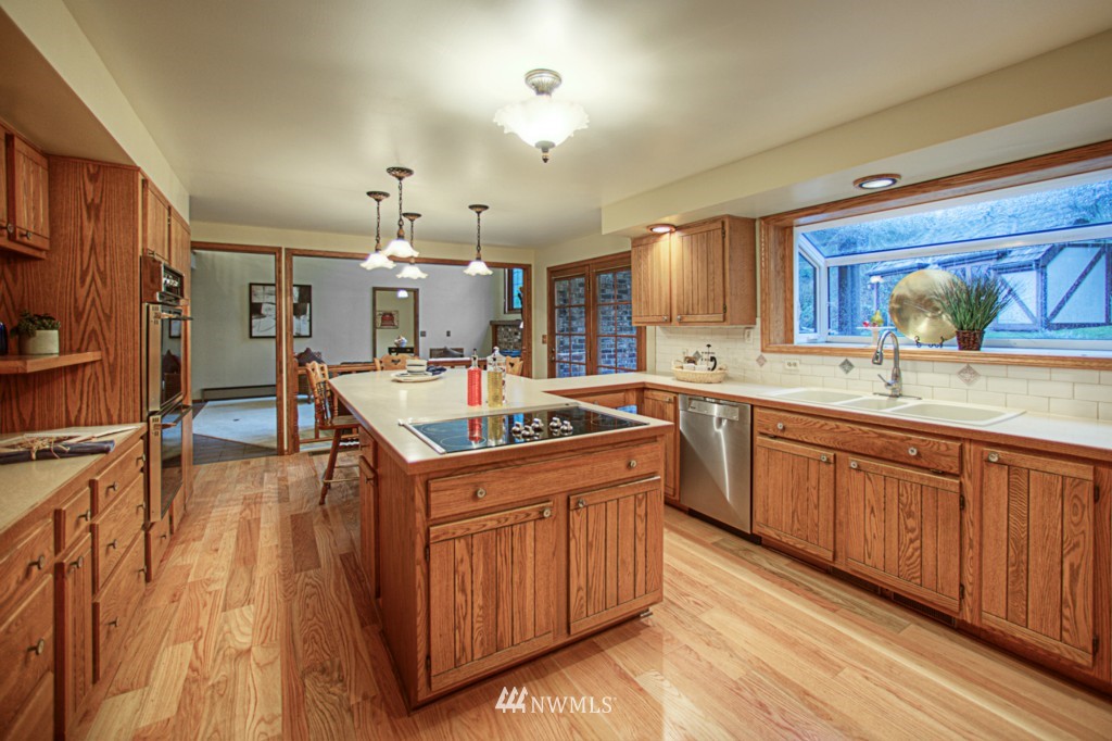 310 208th Street Southeast Bothell, WA 98012 - Photo 5 of 25 a kitchen with a stove sink and cabinets