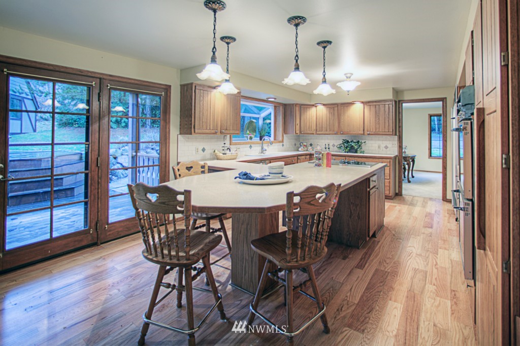 310 208th Street Southeast Bothell, WA 98012 - Photo 6 of 25 a view of a dining room with furniture window and wooden floor