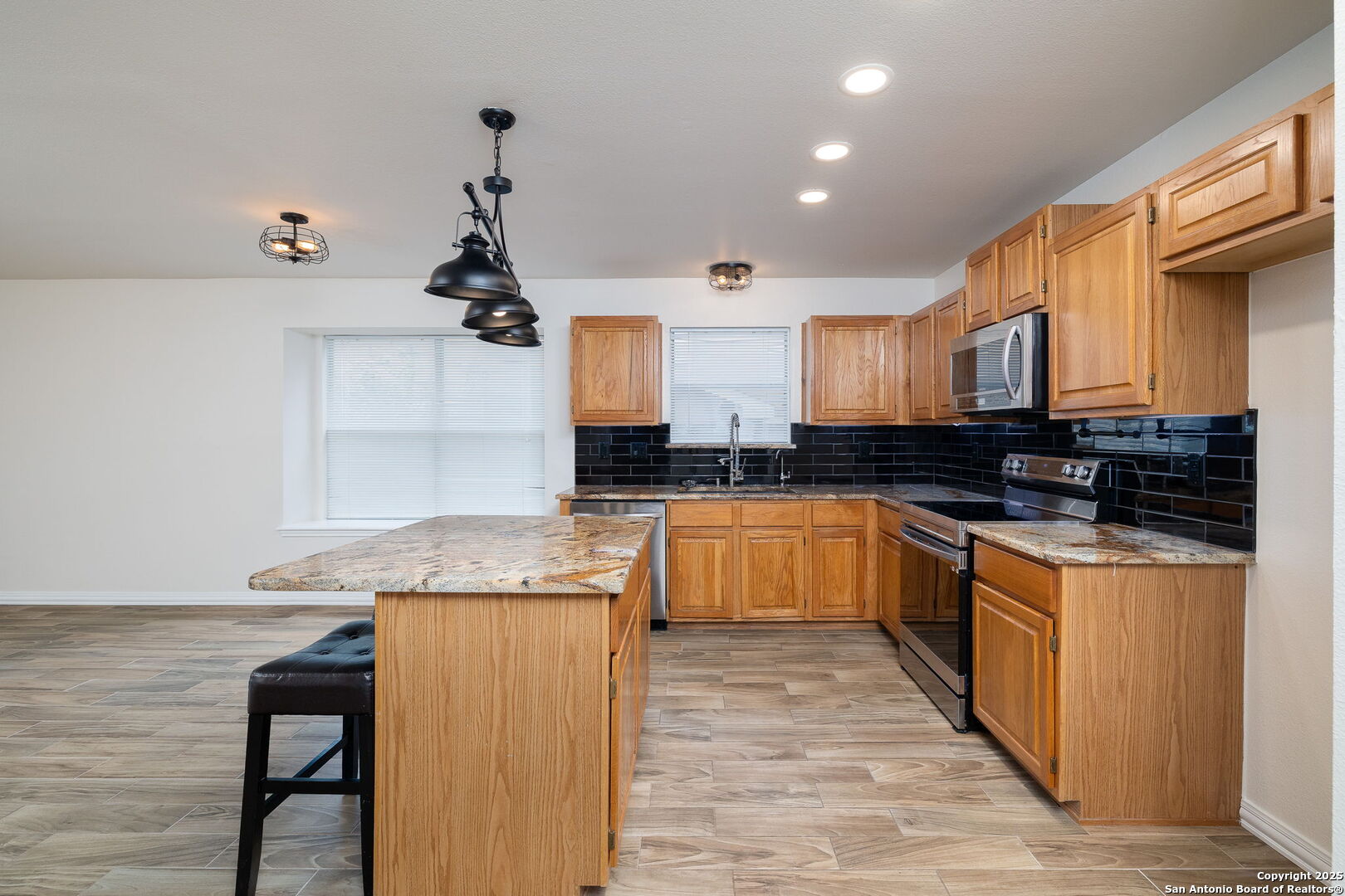 3617 Granite Schertz, TX 78154 - Photo 12 of 29 a kitchen with granite countertop a sink cabinets and wooden floor