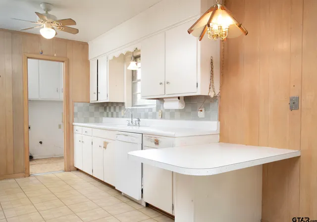 a kitchen with stainless steel appliances a stove a sink and a refrigerator