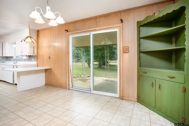 a view of kitchen with granite countertop cabinets and a sink
