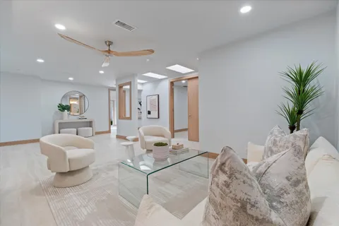a living room with furniture and a chandelier