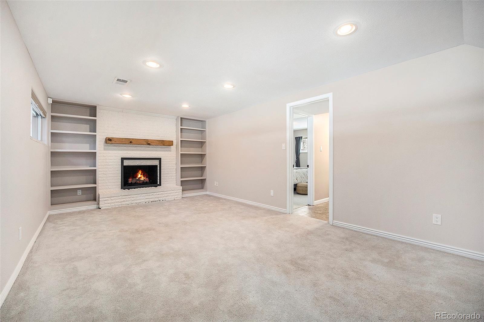 3582 Wright Street Wheat Ridge, CO 80033 - Photo 20 of 31 an empty room with a fireplace and a window