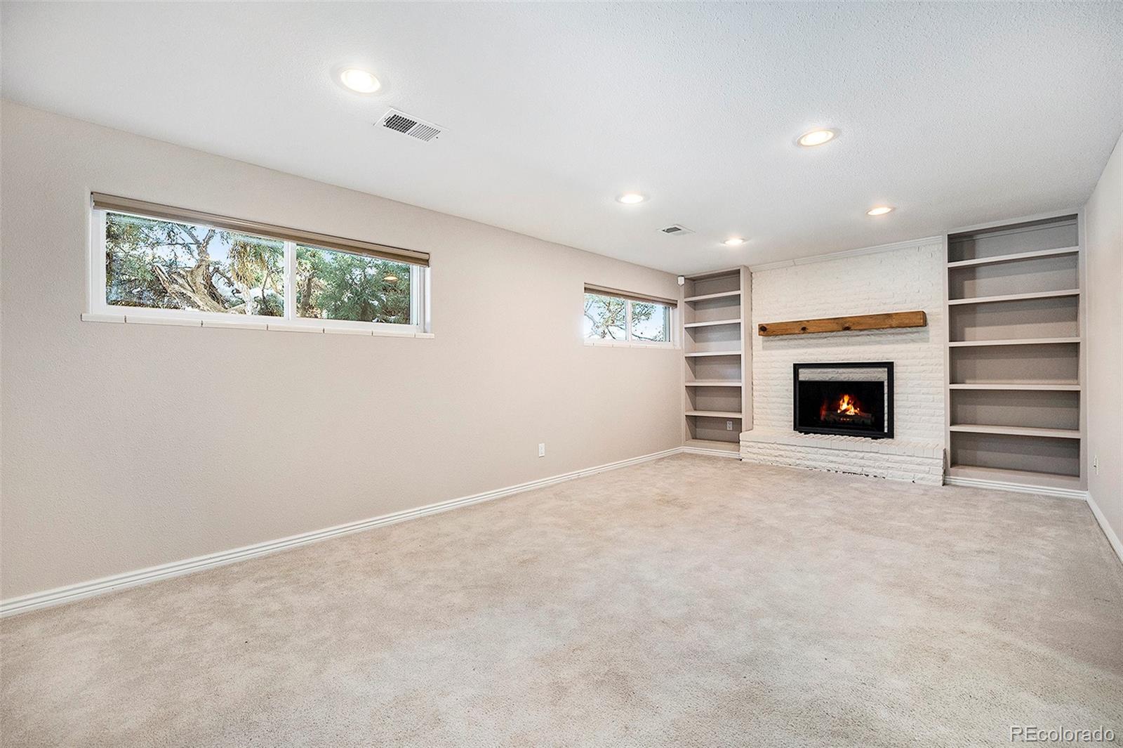 3582 Wright Street Wheat Ridge, CO 80033 - Photo 21 of 31 a view of an empty room with a fireplace and a window