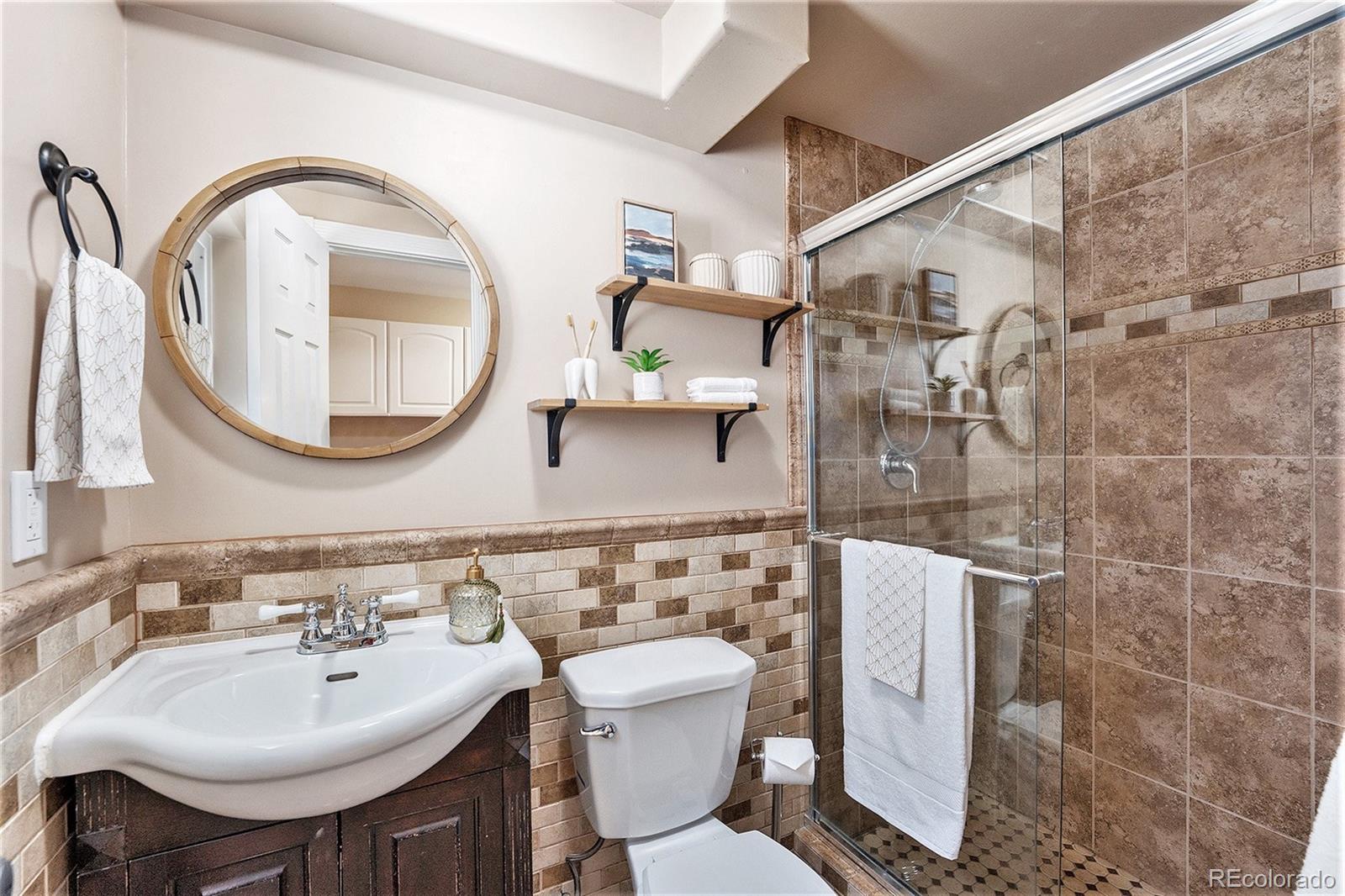 3582 Wright Street Wheat Ridge, CO 80033 - Photo 24 of 31 a bathroom with a sink and a mirror
