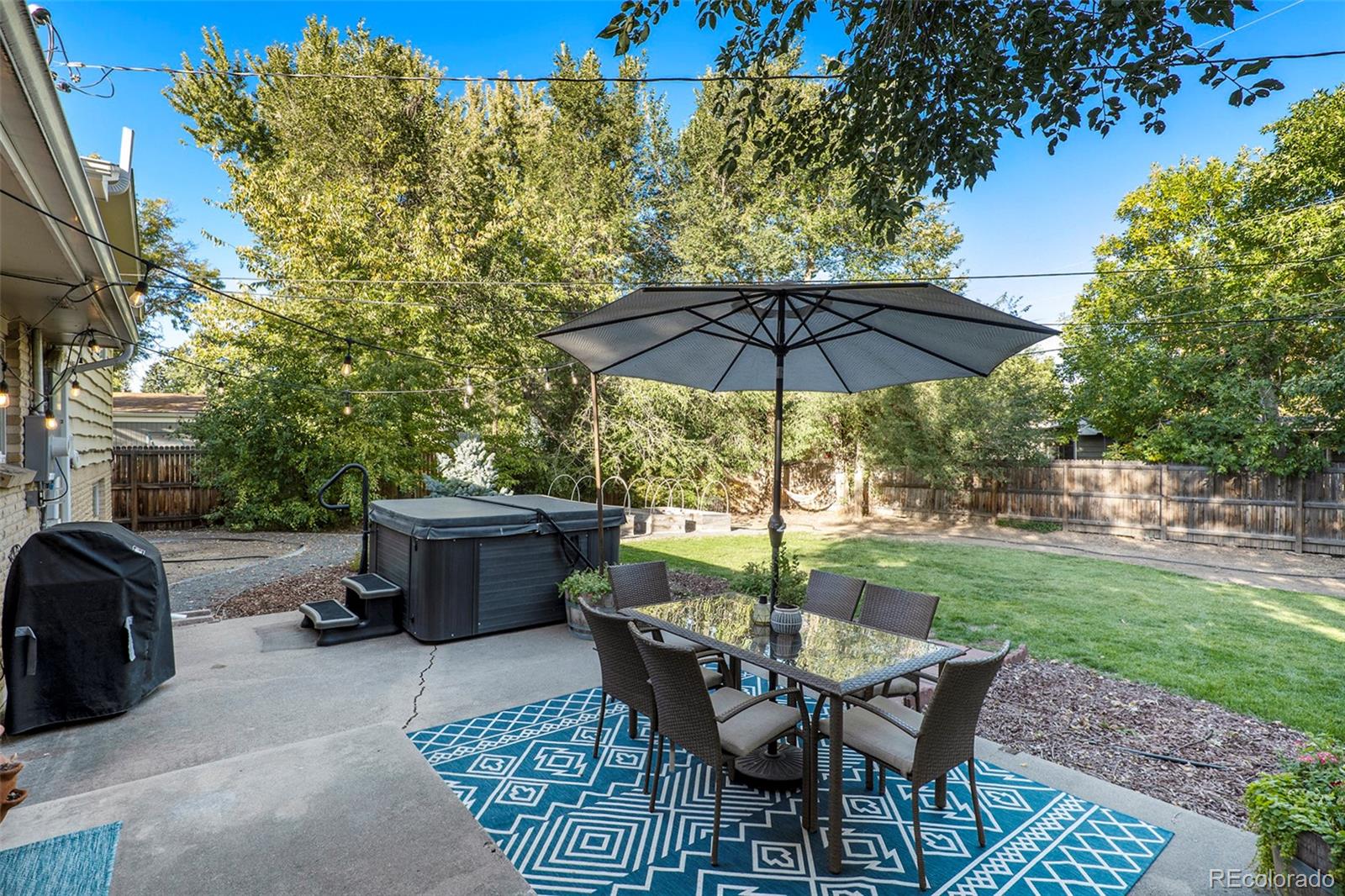 3582 Wright Street Wheat Ridge, CO 80033 - Photo 25 of 31 a view of a backyard with furniture porch and a garden
