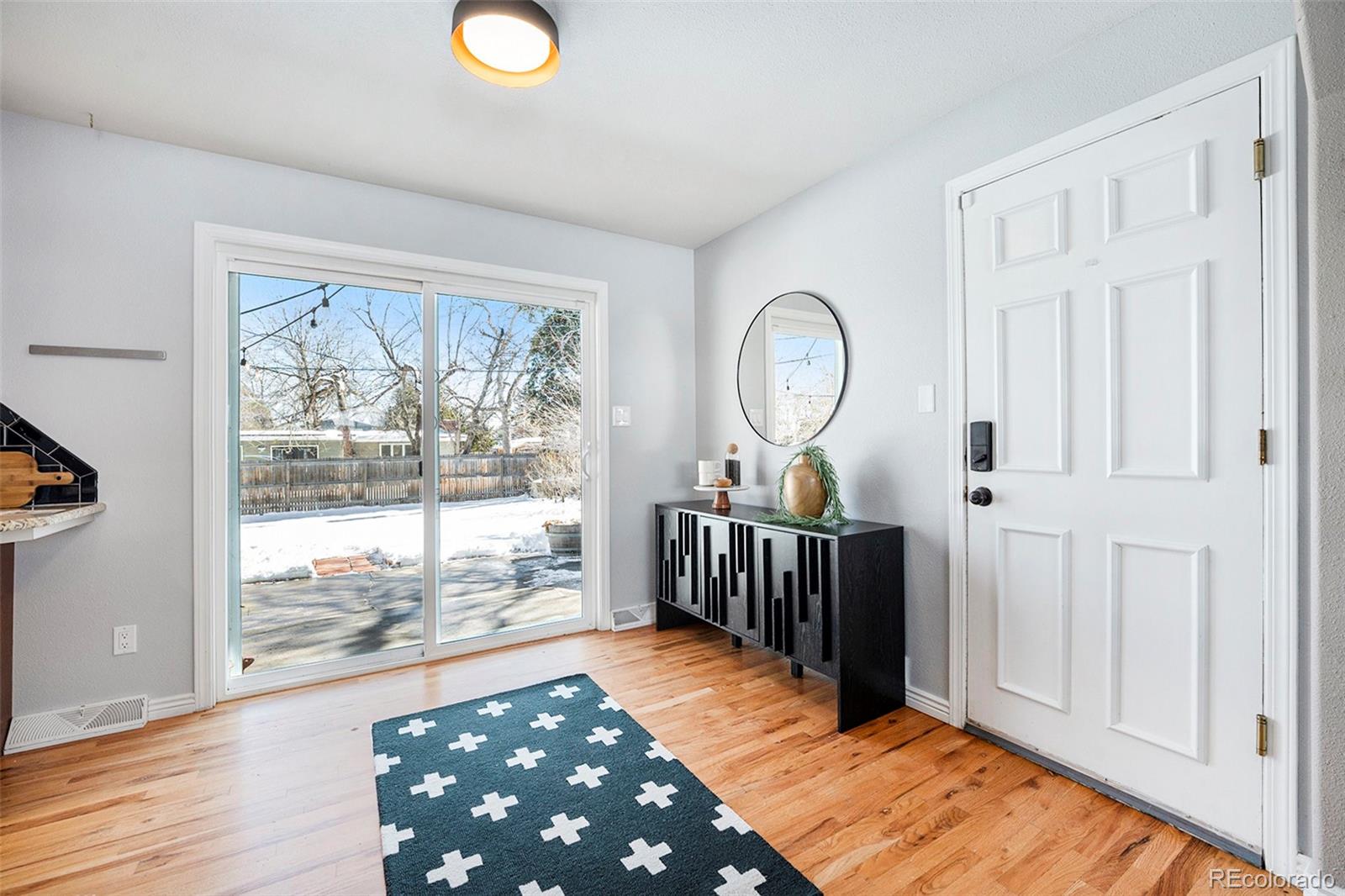 3582 Wright Street Wheat Ridge, CO 80033 - Photo 8 of 31 a view of a room with wooden floor and windows