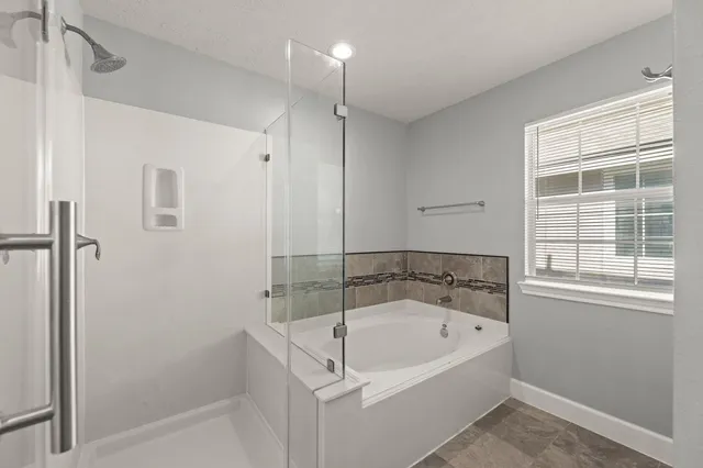 a white bath tub sitting next to a window