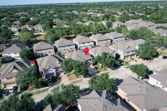 an aerial view of residential houses with outdoor space and street view