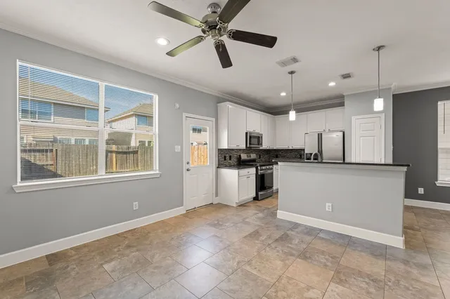 a kitchen with white cabinets and white appliances