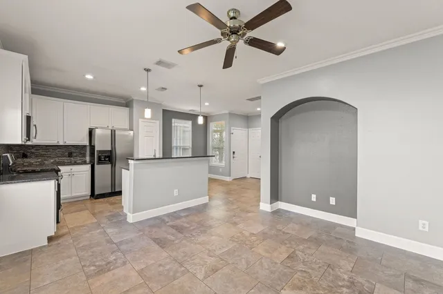 a view of a kitchen with a sink and stainless steel appliances