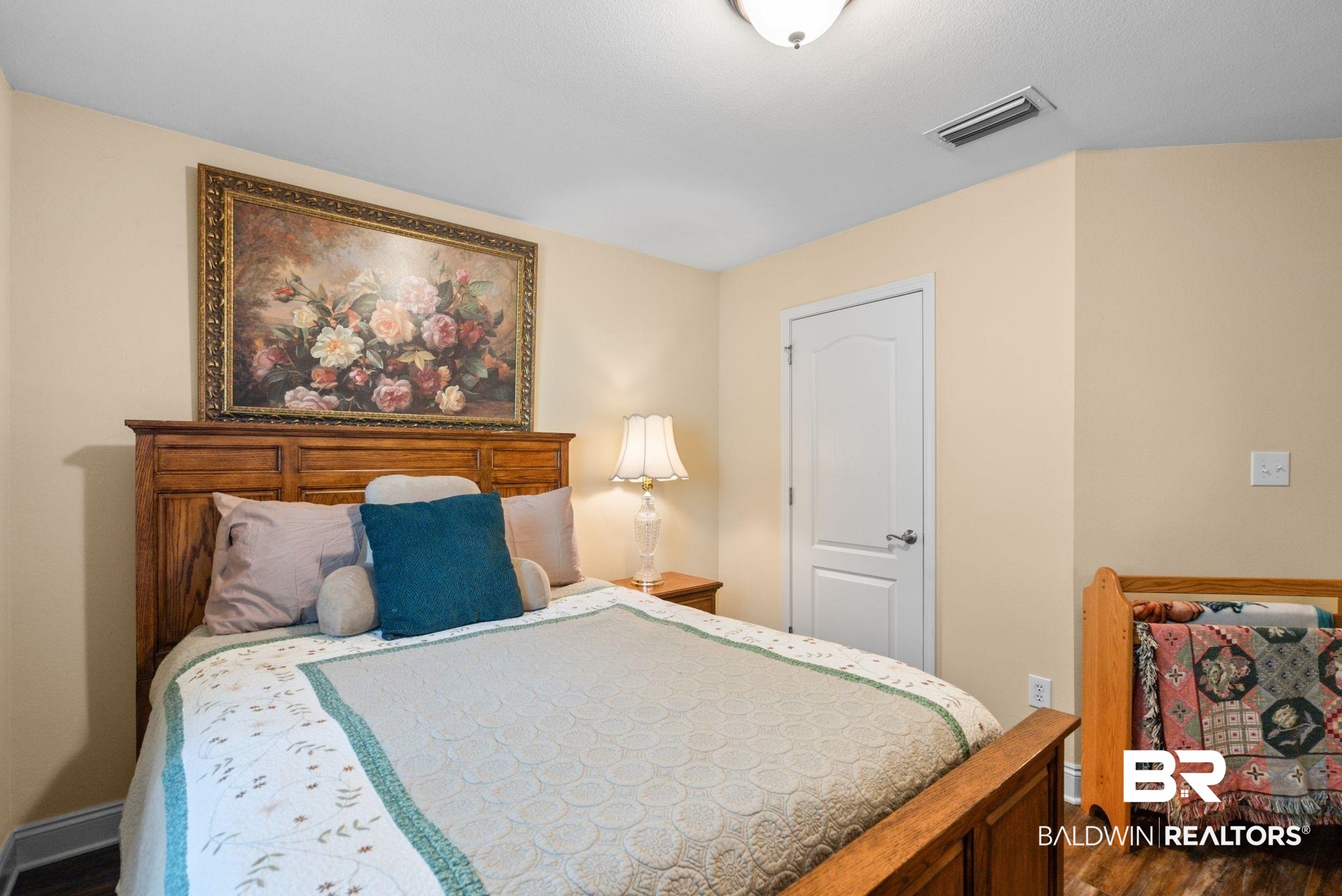 562 Vestige Mews Foley, AL 36535 - Photo 30 of 54 Bedroom with wood-finish flooring, light neutral wall paint, and a classic white panel door