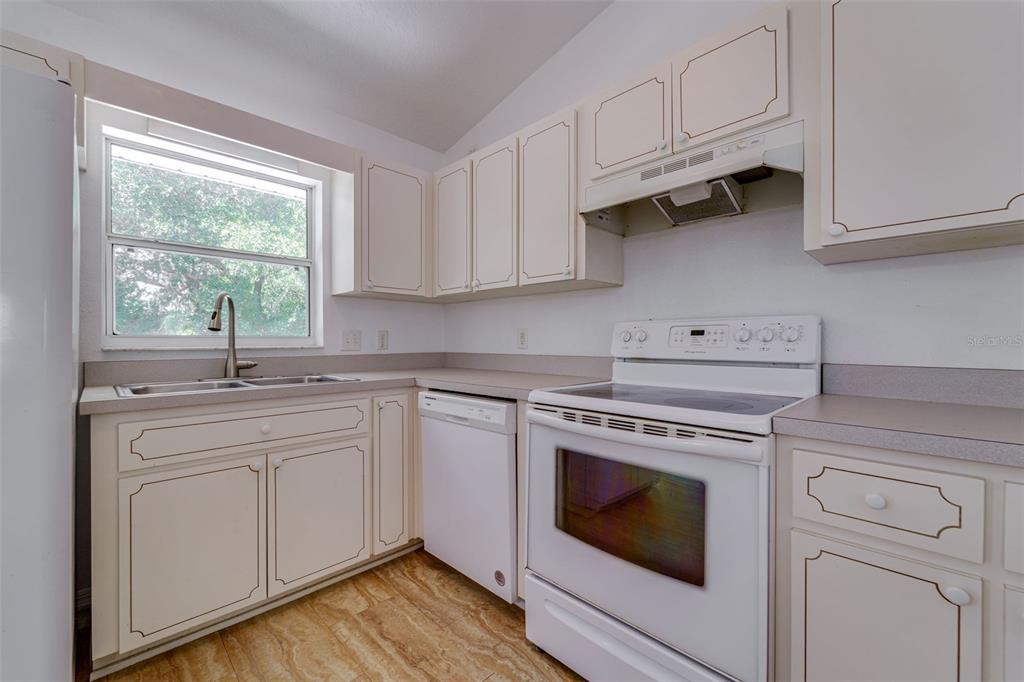 729 Longfellow Terrace Inverness, FL 34450 - Photo 11 of 37 a kitchen with cabinets appliances a sink and a window