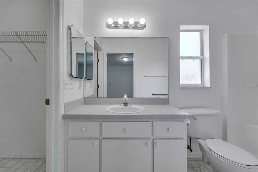 729 Longfellow Terrace Inverness, FL 34450 - Photo 20 of 37 a bathroom with a sink toilet a mirror and window